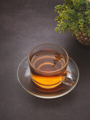 A teacup with flowers placed on a dark background.Space for text. Morning beverage and relaxation concept