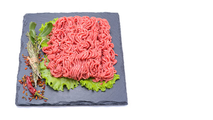 Fresh minced pork and beef and spices on a slate stone.Isolated on a white background, selective focus. horizontal view.