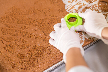 Bakers hands in gloves over biscuit sheet