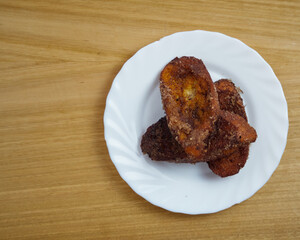 Traditional homemade and Delicious Spanish Torrijas in a white dish. Top View