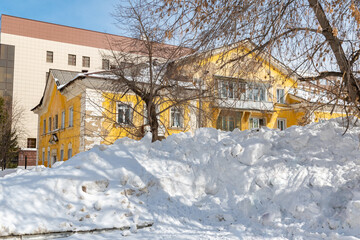 City streets are covered with snow. Snowdrifts reach human height 