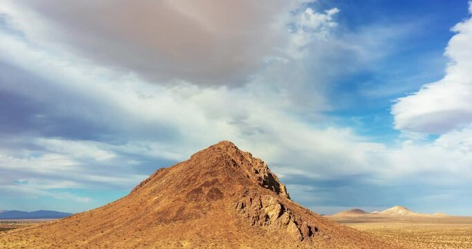 Timelapse of clouds behind desert butte