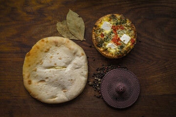 Broccoli quiche and salad leaves on wooden chopping board. Cheese and Broccoli Frittata