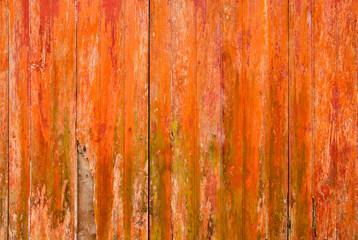 Old distressed orange painted wooden planks wall background