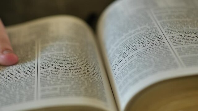 Turning the pages on scriptures.  A think amount of scriptures could represent an LDS Triple combination.