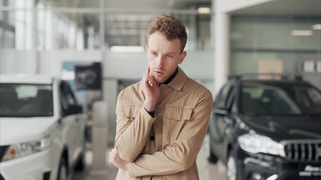 Stylish handsome man standing in front of choosing a car