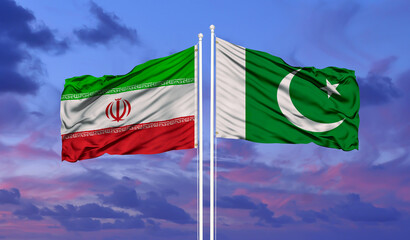 Pakistan and Iran flag waving in the wind against white cloudy blue sky together. Diplomacy concept, international relations.