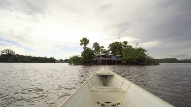 white boat on the oiapoque river amapa amazon brazil rainforest filmed with sony A7iii