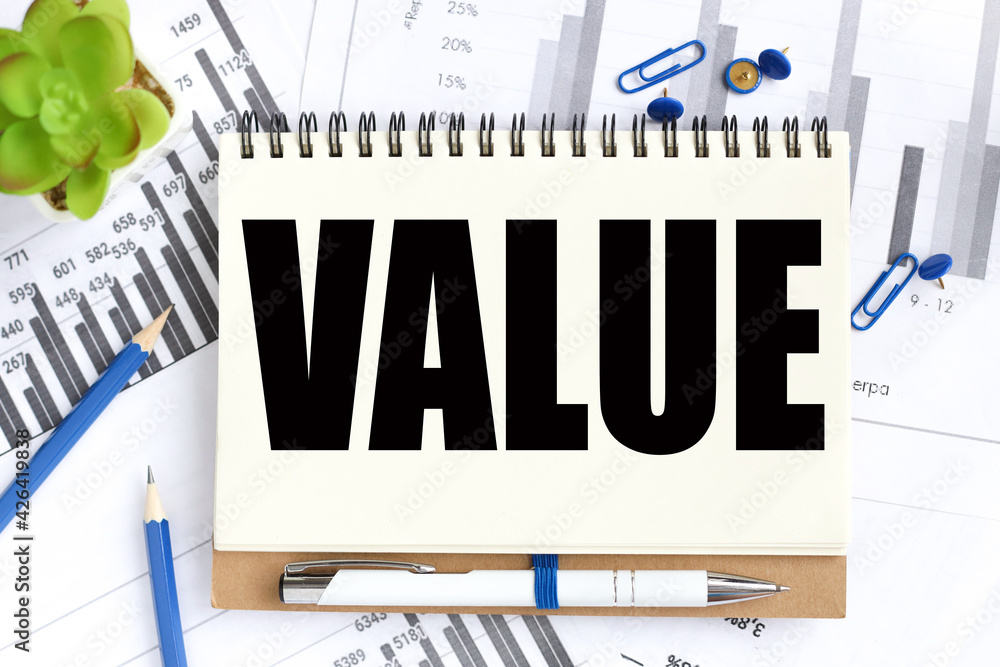 Poster values. text on white notepad paper on a light background near financial charts