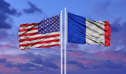 France and United States two flags on flagpoles and blue cloudy sky