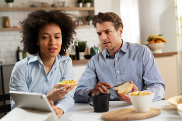 Loving couple drinking coffee and eating sandwich. Happy smiling wife enjoy in the morning with her husband