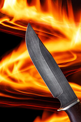 Damascus steel knife on the fire background.
