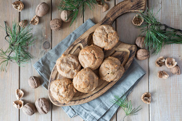 Cottage cheese muffins with nuts on a wooden board. Nut cupcakes for breakfast. Top view.