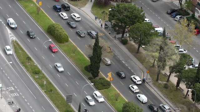 aerial view of main street in madrid with busy traffic, trees between lanes. Paseo de la Castellana