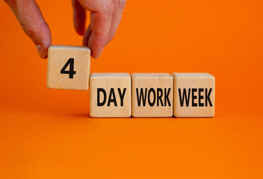 4 day work week symbol. Businessman holds the cube with words '4 day work week'. Beautiful orange background. Copy space. Business and 4 or 5 day work week concept.