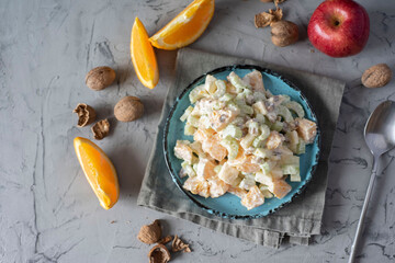 Diet breakfast: celery, orange and apple salad on a nice plate. Top view