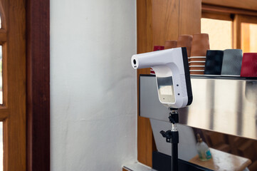 Infrared thermometer of touchless setting on front of counter store