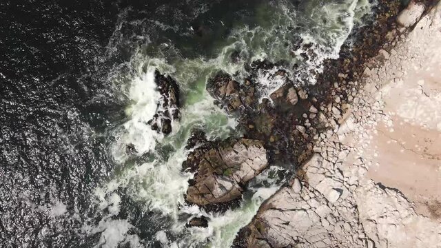 Overhead view at El Canelo Beach in Chile with waves crashing against the shore