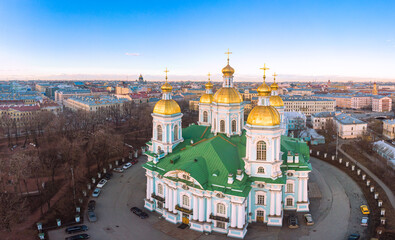 Aerial top view to St. Nicholas Naval Sea Cathedral in sunny day. Panorama of evening historical city center. Orthodox church located on banks of Kryukov and Griboyedov canal. Saint Petersburg. Russia