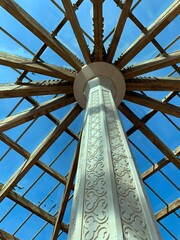 Wood trusses radiating from center of a wooden roof
