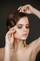 Fototapeta premium portrait of a woman with makeup on a dark background