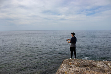 Boy fishing in the sea
