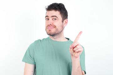 No sign gesture. Closeup portrait unhappy young handsome caucasian man wearing green t-shirt...