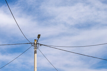 Rural power line against the blue sky. Electricity pole