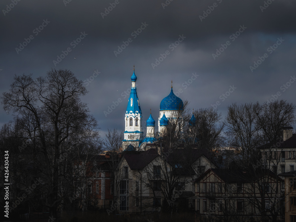 Wall mural ancient christian temple in dark spring day. st. basil's cathedral in the historic centre of gatchin