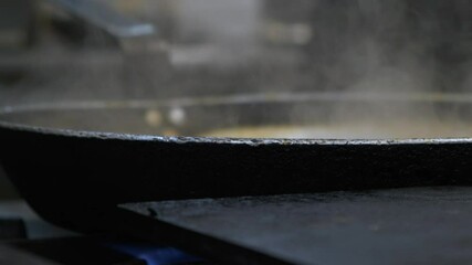 Pan with Hot Steam Close Up In a Restaurant Kitchen and a Chef Adjusting It