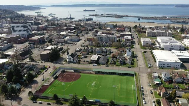 Cinematic birdseye drone clip of downtown Everett, Bayside, Port Gardner, Naval Station Everett suburbs, bedroom communities North of Seattle on the shores of Puget Sound in Washington