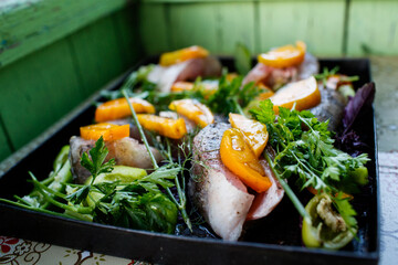 Homemade zander fish with vegetables and herbs