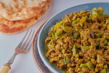 Indian minced beef dish with naan bread.