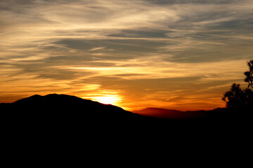 Brightly colored sunset due to the presence of some light clouds, from the natural park of El Valle.