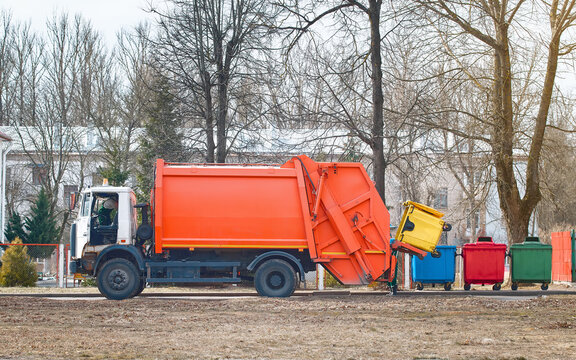 Garbage truck remove waste from city street. Collection and transportation of domestic garbage by municipal service. Sort and dispose waste. Different colored recycle waste bins, recycling concept