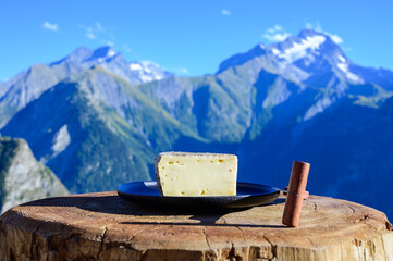 Cheese collection, French tomme de savoie or tome des bauges cheese served outdoor with Alpine...