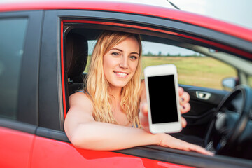 Fototapeta na wymiar Woman in car shows smartphone with blank screen.