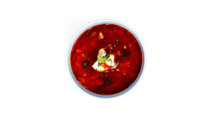 Red, hot borscht - beet soup with sour cream and herbs isolated on a white background.