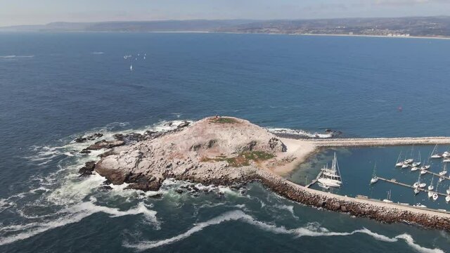 Aerial view of El Canelo Beach on the yatch parking on a sunny day at the shore 