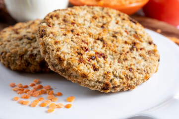 Tasty vegetarian food, burgers made from orange lentils legumes with sun dried tomatoes