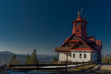 Naklejka premium Pancir hill with building with red roof in spring winter sunny morning