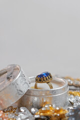 Beautiful golden ring with blue sapphire precious stone. Vintage jewelry background. Jewel, closeup, close up, macro, studio shot