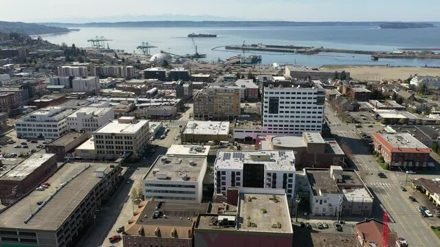 Cinematic aerial drone panning footage of downtown Everett, Bayside, Port Gardner, Naval Station Everett suburbs, bedroom communities North of Seattle on the shores of Puget Sound in Washington