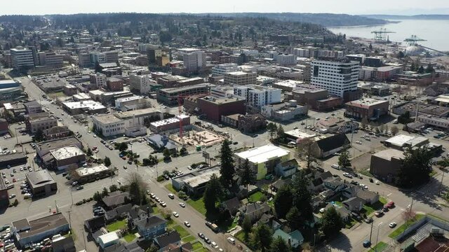 Cinematic aerial drone shot of downtown Everett, Bayside, Port Gardner, Naval Station Everett suburbs, bedroom communities North of Seattle on the shores of Puget Sound in Washington