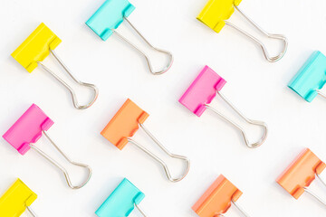 Multicolored binder clips isolated on white background