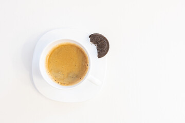 Cup of coffee on saucer with cookie isolated on white background and copy space for text