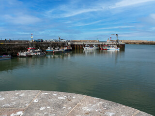 Port-en-Bessin-Huppain, France, March 2021. A small picturesque fishing port in Normandy. Standing...