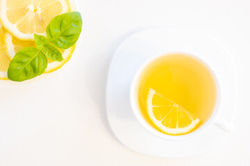 Cup of green tea top view with lemon, basil and mint shoot from above isolated on white background with copy space for text