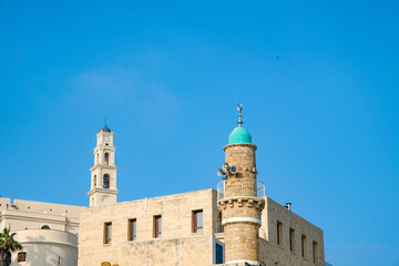 Fototapeta na wymiar View of the St. Peter`s Church, bell tower of the Saint Peter Church and the al-Bahr Mosque or Sea Mosque in Old Jaffa, Tel Aviv Yaffo, Israel.