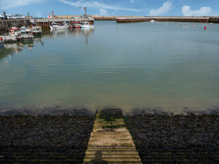 Port-en-Bessin-Huppain, France, March 2021. A small picturesque fishing port in Normandy. Standing...